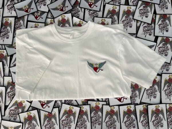 A white shirt with a red and green bird on the chest.